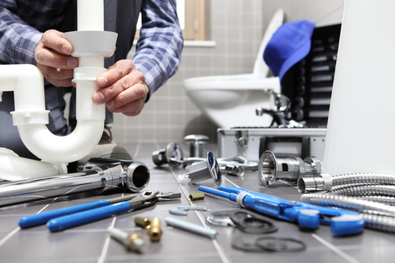Our plumbing expert doing a drain repair in a bathroom in Toronto, ON